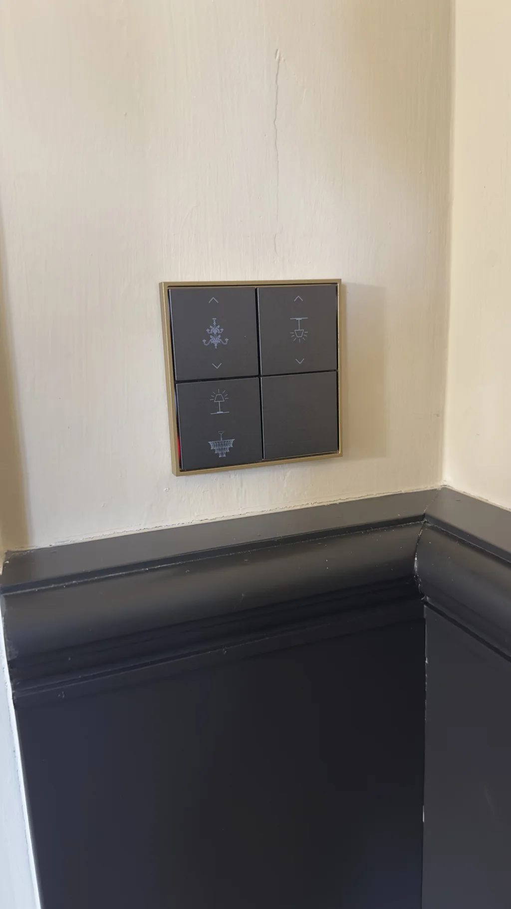 Ekinex keypad mounted cleanly above dark skirting on a plastered wall