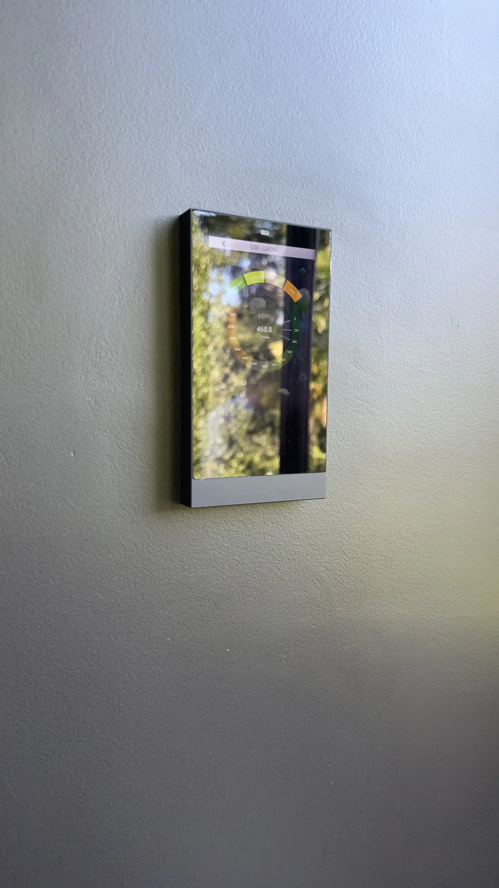 Ekinex glass touch panel mounted on a dark feature wall