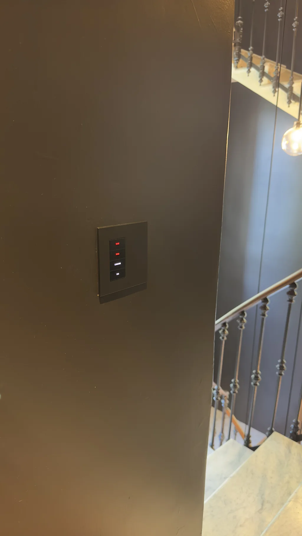 Ekinex glass touch-panel beside an ornate staircase balustrade