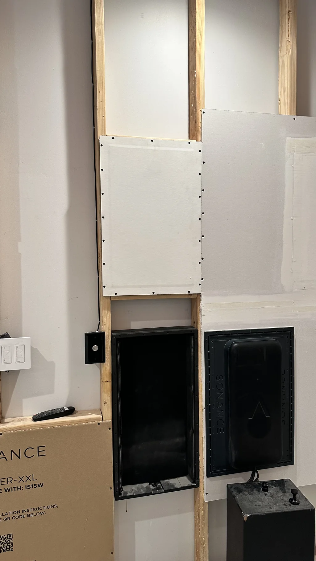Sonance Invisible Series speakers fixed into a framed training wall before plastering